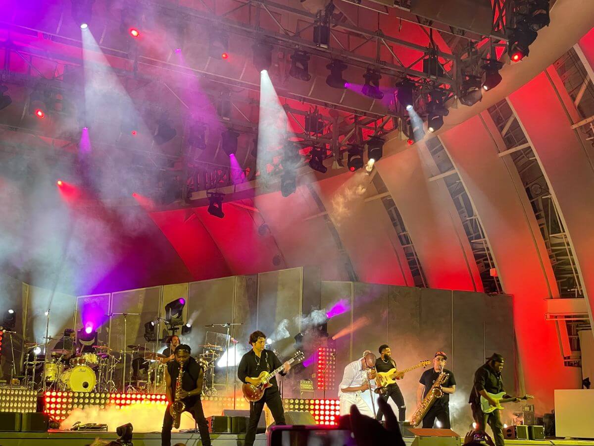 performers on stage with neon red and purple lights at The Hollwood Bowl in LA, California