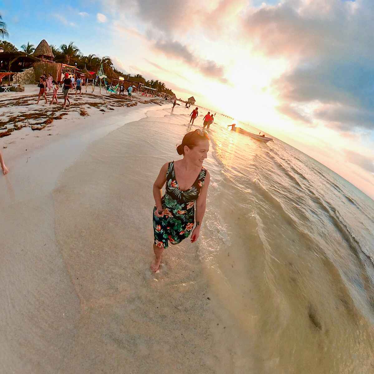 woman walking Playa Holbox at sunset