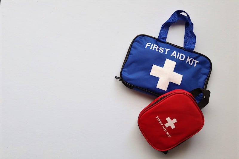 red and blue first aid kits side-by-side