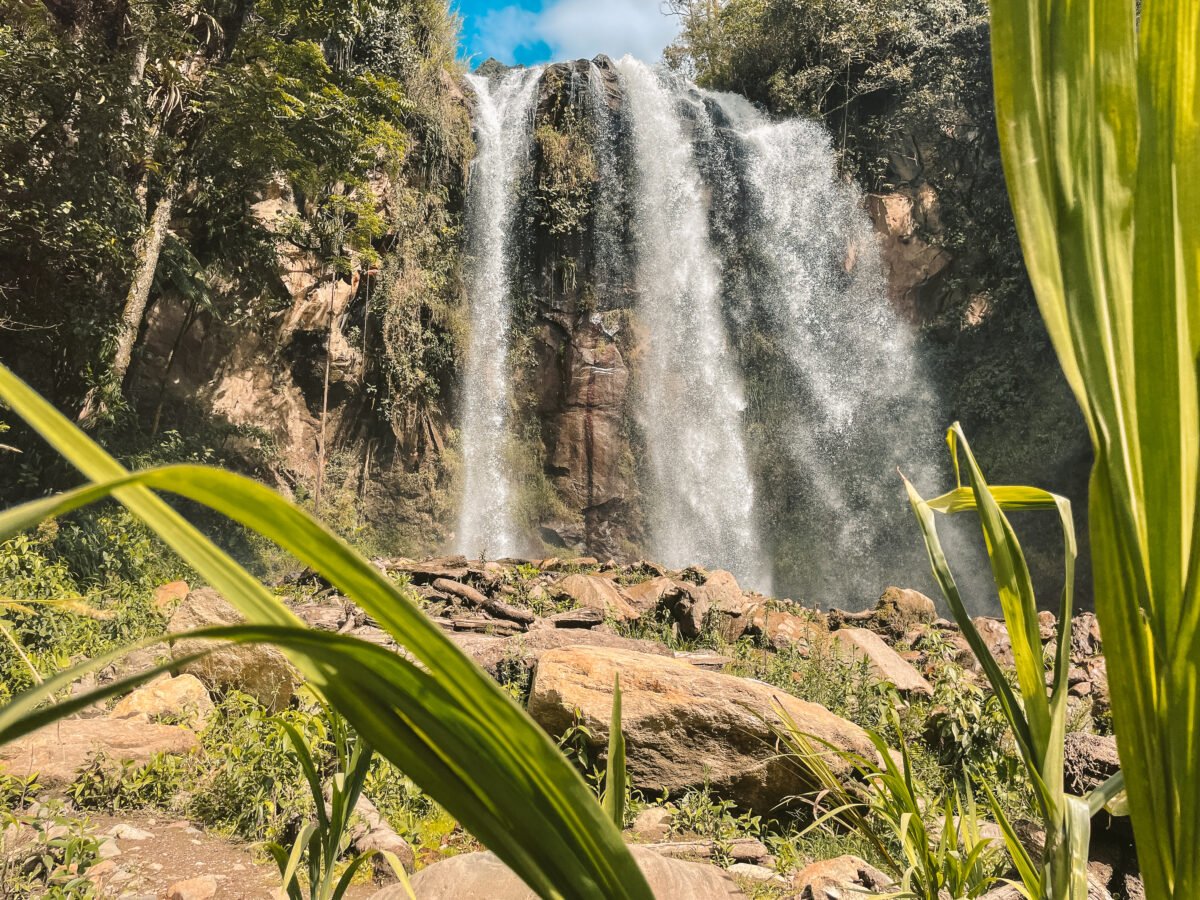 Close-up view of the Cascada Silencio in Baños, Ecuador, framed by lush green foliage, highlighting the natural beauty and tranquility of this popular spot for solo travelers exploring Ecuador.