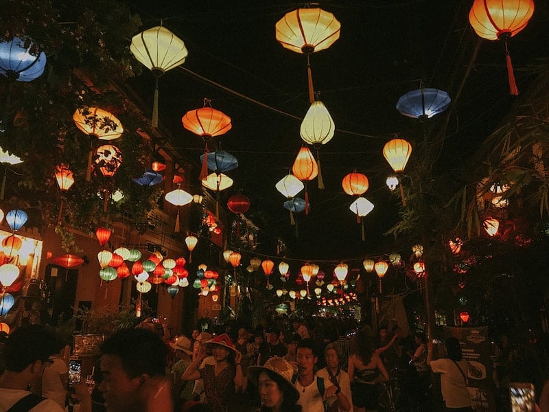 walking under bright lanterns in Hoi Ann, Vietnam while traveling solo in Asia