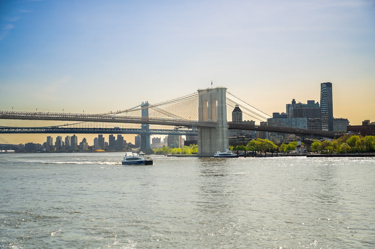 view of the Brooklyn Bridge and East River from The Seaport neighborhood of Manhattan