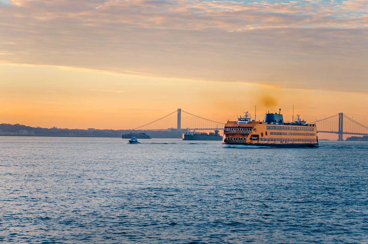 Staten Island Ferry at dawn with views of the bridge and New York Harbor