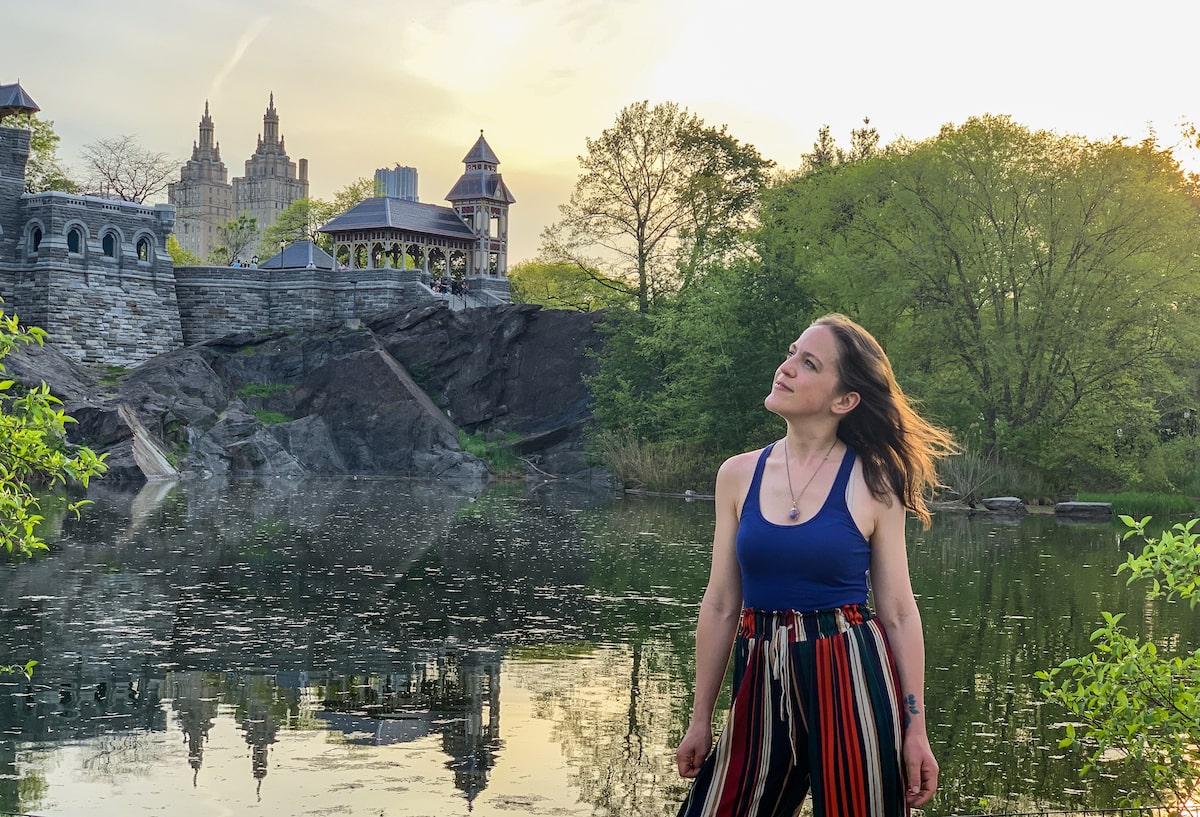 woman gazing out at the view over Turtle Pond and Belvedere Castle in Central Park, NYC